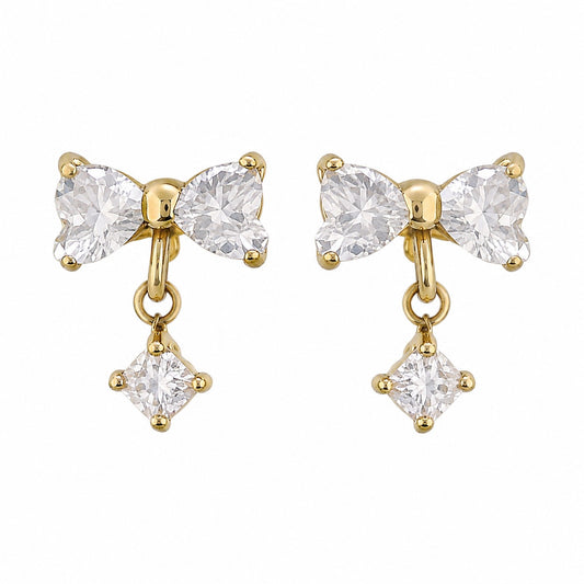 A pair of gold bow-shaped drop earrings with clear gemstones, shown on a plain white background.